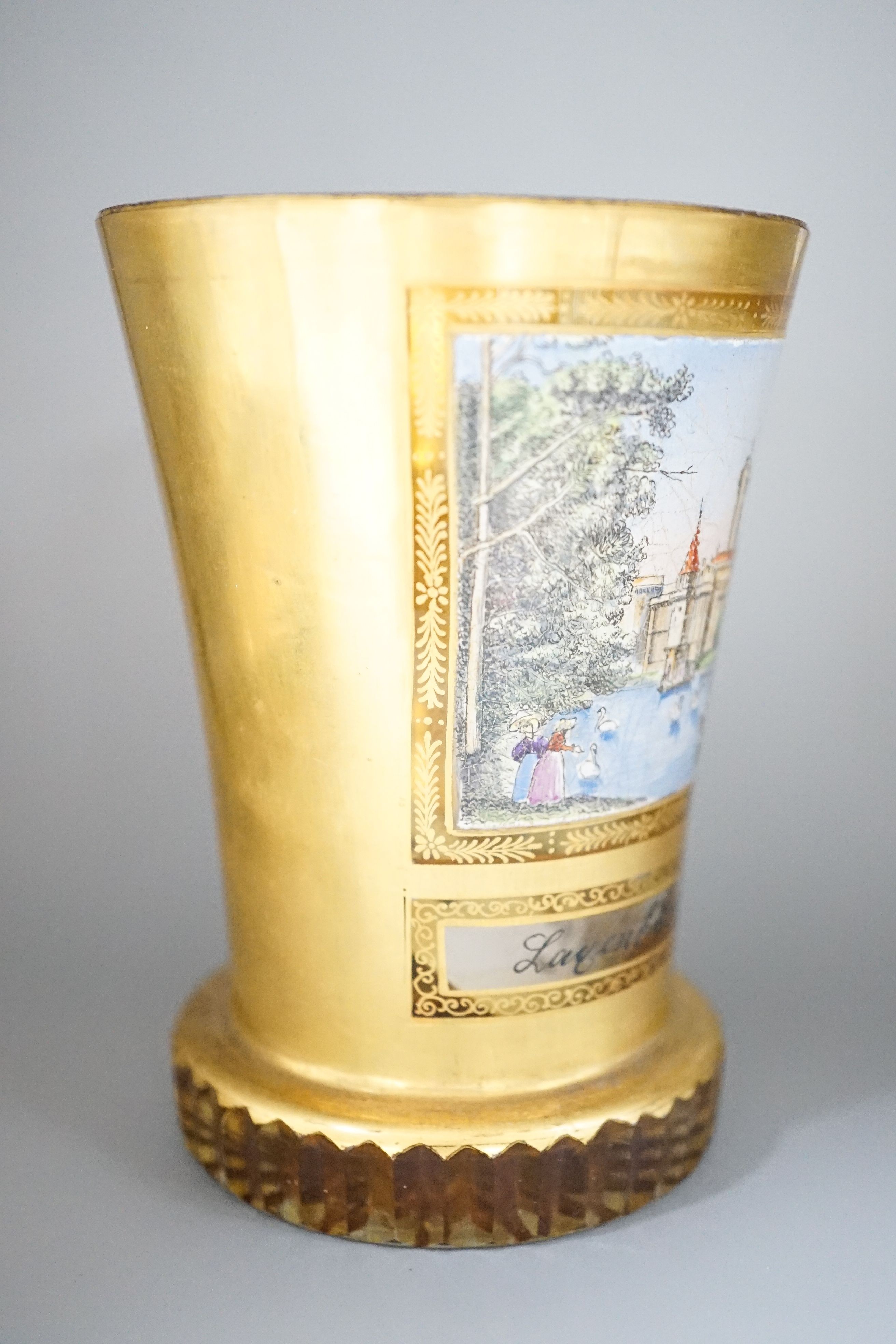 A 19th century Bohemian enamelled and gilded glass beaker 11cm, with titled scene Layenburg bei Wien